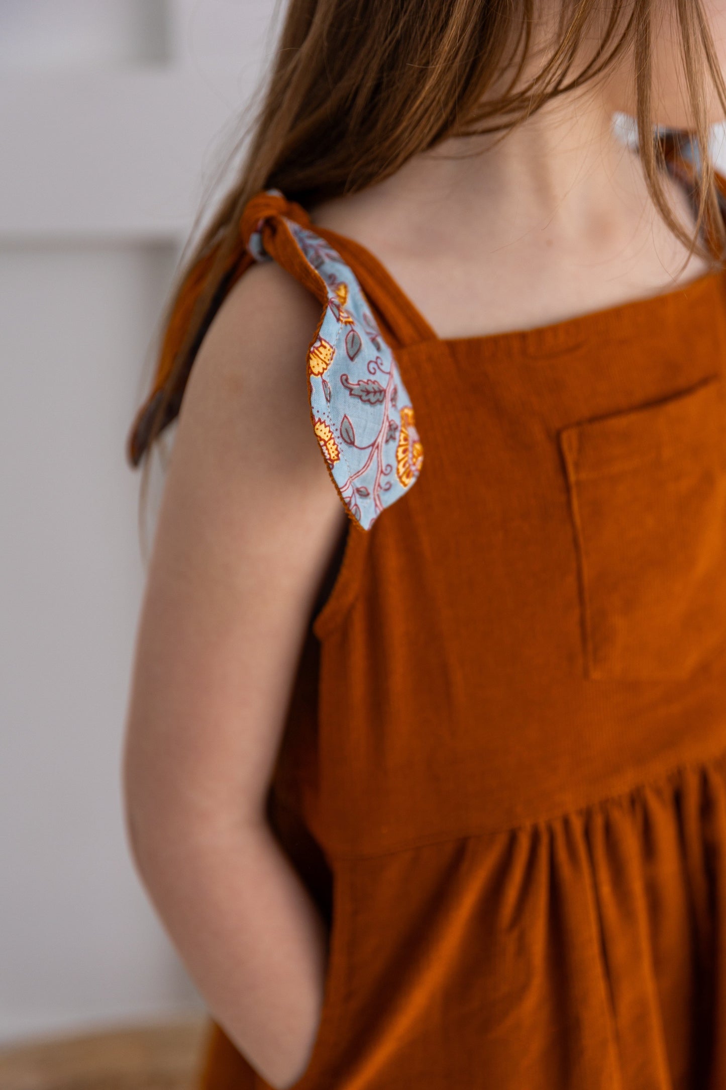 Reversible Solid Rust Corduroy & Rust Floral Printed Ruffle Dress DRESS Yo Baby India
